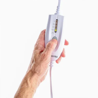 Close-up of the BodyMed heating pad LED controller showing the four heat settings and mode options.