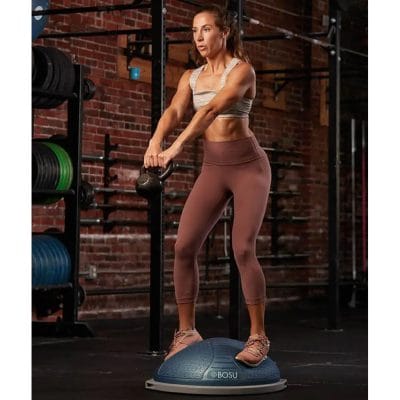 Person performing dumbbell strength training while balancing on BOSU NexGen Pro