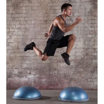 Athlete performing plyometric jump training between BOSU Balance Trainer Pro units to improve balance and agility.