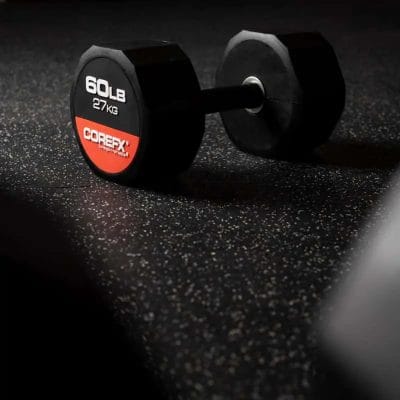 Single CoreFX 60 lb rubber dumbbell on a commercial gym floor