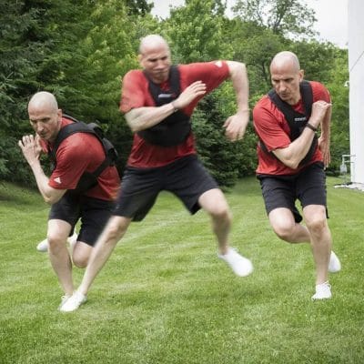 Athlete performing lunges while wearing CoreFX 20 lb weighted vest
