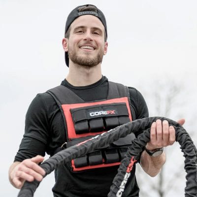 Athlete holding CoreFX battle rope while wearing CoreFX Pro weighted vest
