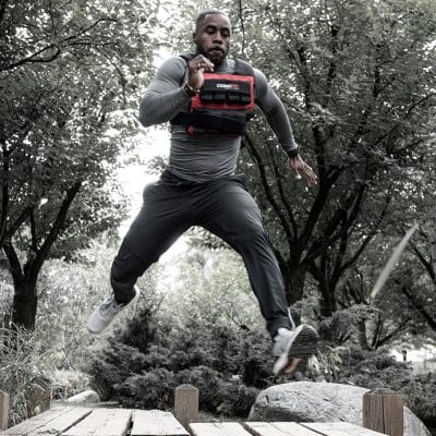 Athlete performing jog with CoreFX Pro 40 lb weighted vest