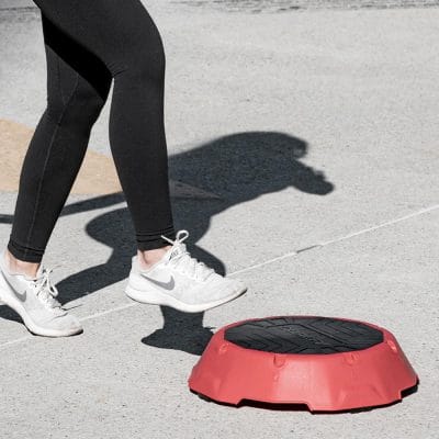 Close-up of foot stepping onto a CoreFX aerobic step riser during workout
