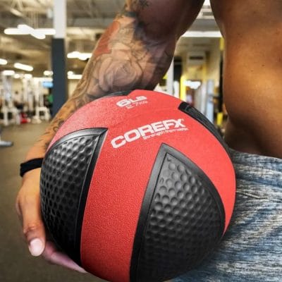 Person holding CoreFX medicine ball during core training exercise