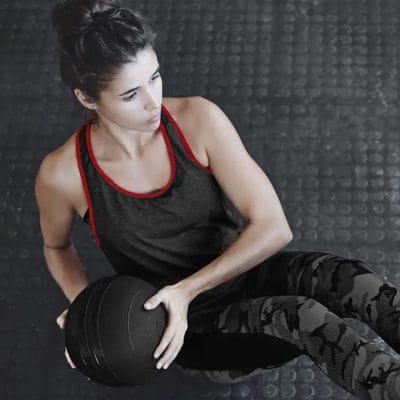 Person doing slam ball squat-to-slam exercise with CoreFX slam ball