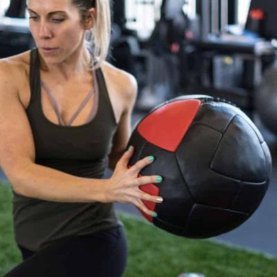Person catching a CoreFX wall ball after a wall throw exercise