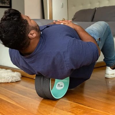 Individual performing spinal stretch using 10-inch Chirp Wheel+