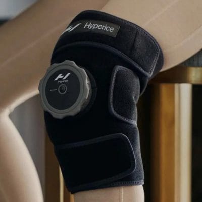 Person wearing the Hyperice Ice Compression Knee Wrap during icing session