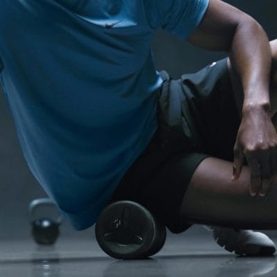 Hyperice Vyper 3 vibrating foam roller on a gym floor close-up