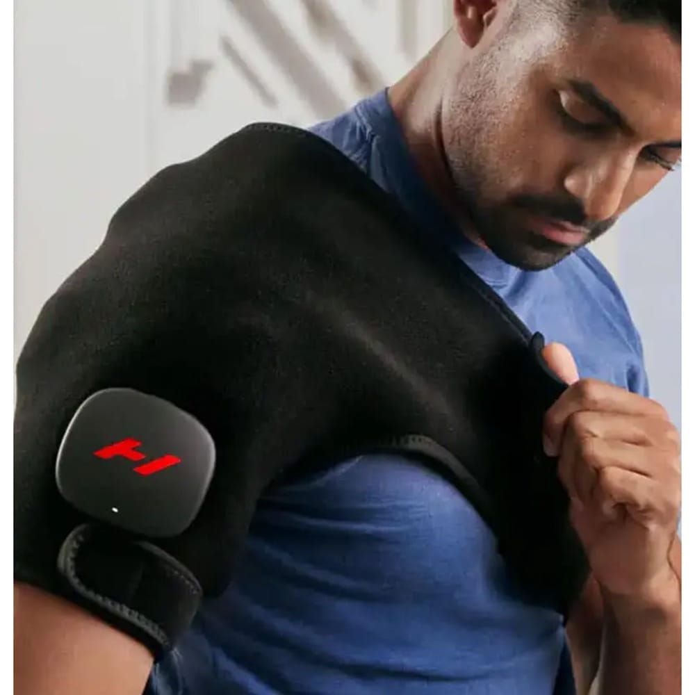 Person wearing the Hyperice Venom 2 Shoulder wrap while treating shoulder pain