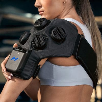 Side view of the Hyperice X2 Shoulder wrap showing the contoured pad and adjustable shoulder and arm straps for secure positioning.