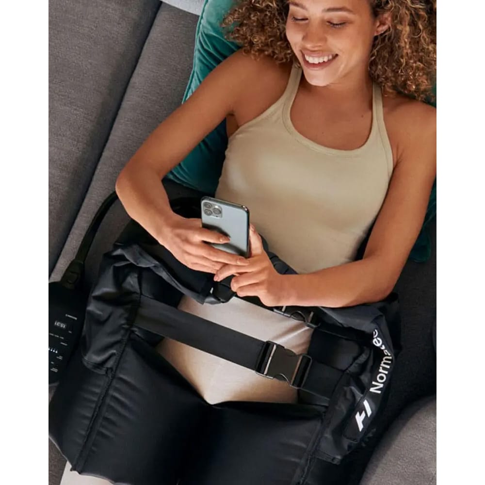 Person using Hyperice Normatec Hip Attachment during compression therapy session