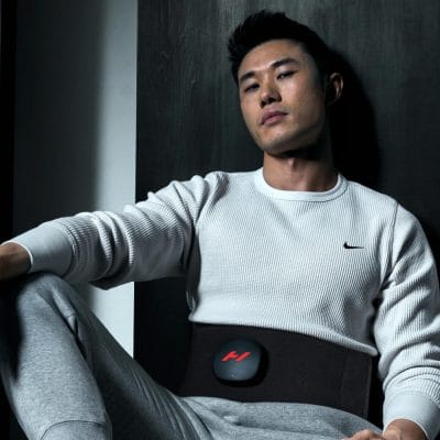 Person wearing the Hyperice Venom 2 Back for lower back heat therapy