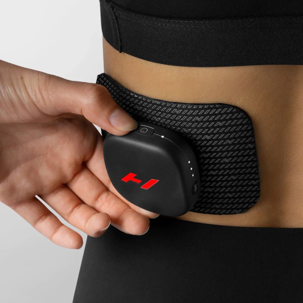 Close-up of Hyperice Venom Go magnetic pod attached to reusable adhesive pad