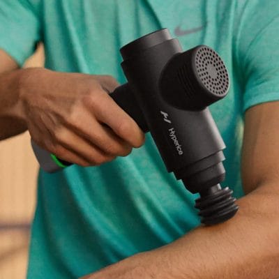 Person applying the Hypervolt 2 Pro to the forearm to help relieve pain and tightness related to tennis elbow.