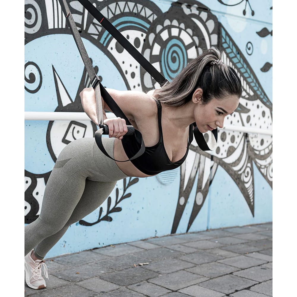 Person performing push-ups using CoreFX suspension system straps