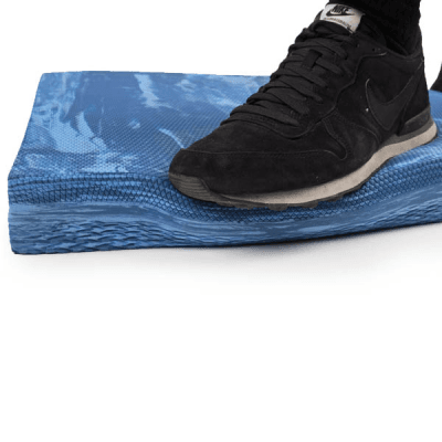 Person standing on Concorde balance pad for single-leg balance training
