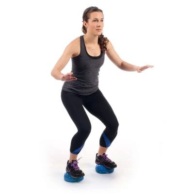 Athlete balancing on one Concorde Balance Pod during a functional exercise, showing dynamic stability and core engagement.