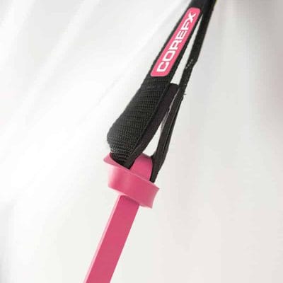 Door anchor securing pink COREFX strength band for home resistance training