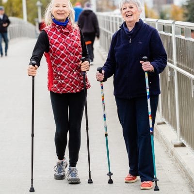 Older adult using ACTIVATOR walking poles for stable outdoor mobility