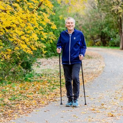 ACTIVATOR Evening Black walking poles used by older adult on outdoor walking path