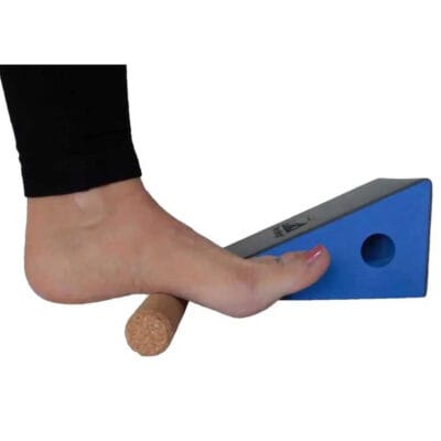 Person using the ThermaWedge foot roller to massage the plantar fascia for plantar fasciitis relief