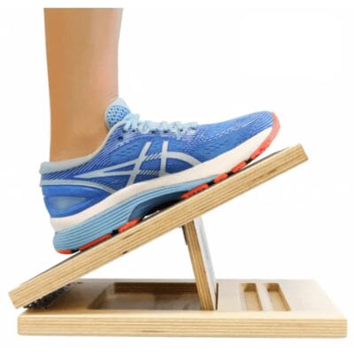 Person performing calf stretch using Fitterfirst adjustable slant board