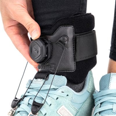 Infracare drop foot brace worn with shoe to assist dorsiflexion while walking